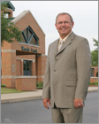 Publicity Portrait of man in front of building